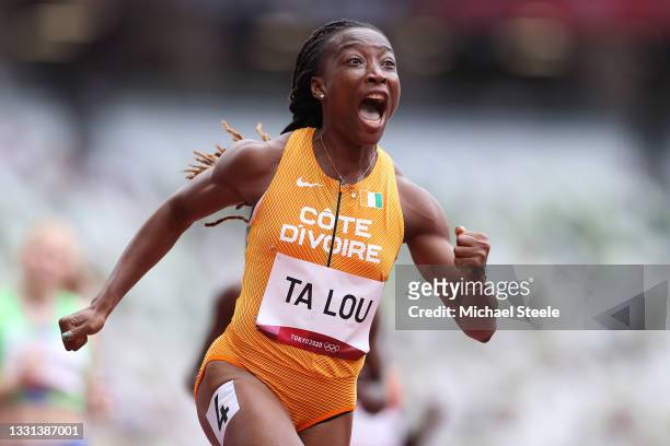 Marie-Josee Ta Lou of Team Ivory Coast reacts while competing during round one of the Women's 100m heats on day seven of the Tokyo 2020 Olympic Games...