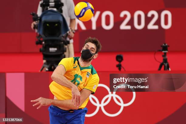 Lucas Saatkamp of Team Brazil wears a face mask while serving against Team United States during the Men's Preliminary Round - Pool B volleyball on...