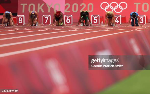 Athletes prepare to compete during round one of the Women's 100m heats on day seven of the Tokyo 2020 Olympic Games at Olympic Stadium on July 30,...