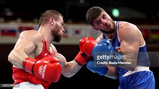 Imam Khataev of Team Russian Olympic Committee exchanges punches with Gazimagomed Scham. Jalidov Gafurova of Team Spain during the Men's Light Heavy...