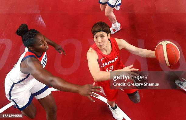 Rui Machida of Team Japan drives to the basket against Chelsea Gray of Team United States during the second half of a Women's Preliminary Round Group...