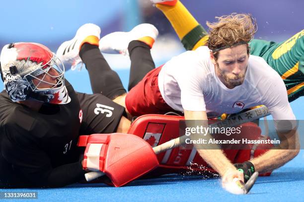 Antoni Pawel Kindler and James Alexander Paget Kirkpatrick of Team Canada defend the goal during the Men's Preliminary Pool A match between Canada...