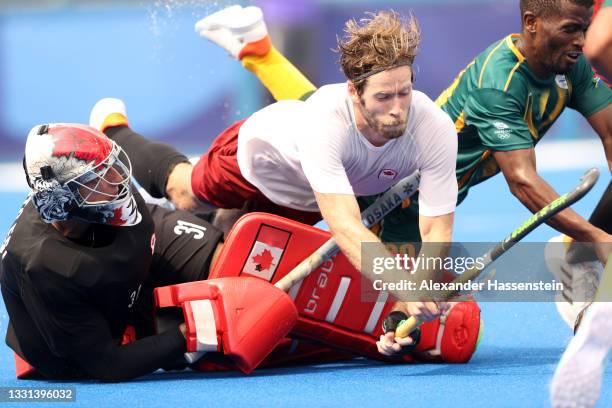 Antoni Pawel Kindler and James Alexander Paget Kirkpatrick of Team Canada defend the goal during the Men's Preliminary Pool A match between Canada...