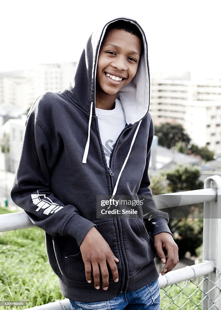 Portrait of young boy wearing hoody and smiling