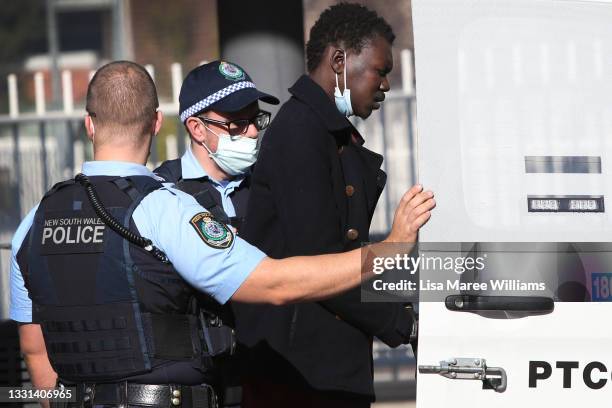 Police Officers apprehend a person at the Fairfield transit hub on July 30, 2021 in Sydney, Australia. Covid-19 lockdown restrictions in hot spot...