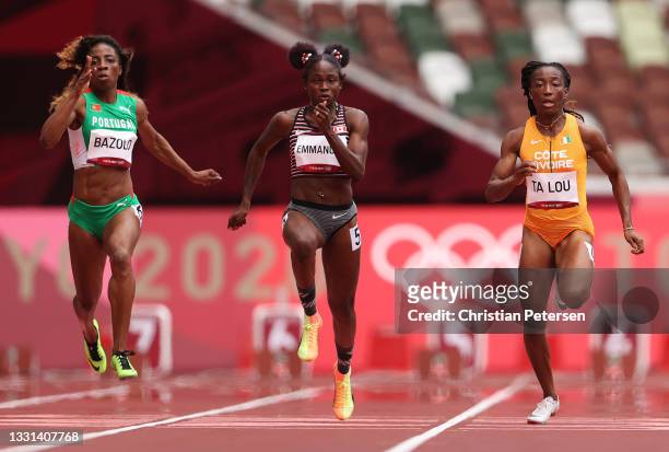Marie-Josee Ta Lou of Team Ivory Coast, Crystal Emmanuel of Team Canada and Lorene Dorcas Bazolo of Team Portugal compete in the Women's 100 metres...