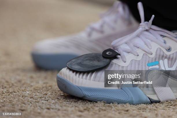 The bow rest is seen on the shoe of Jiaxin Wu of Team China is seen competes in the archery Women's Individual quarterfinals on day seven of the...