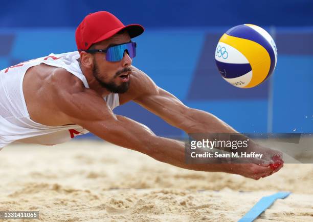 Bartosz Losiak of Team Poland competes against Team Italy during the Men's Preliminary - Pool F beach volleyball on day seven of the Tokyo 2020...
