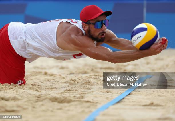 Bartosz Losiak of Team Poland competes against Team Italy during the Men's Preliminary - Pool F beach volleyball on day seven of the Tokyo 2020...