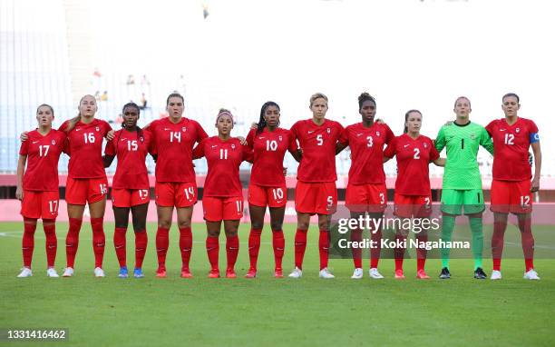 Players of Team Canada stand for the national anthem prior to the Women's Quarter Final match between Canada and Brazil on day seven of the Tokyo...