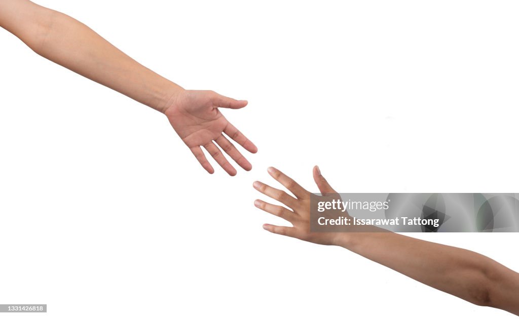 Closeup shot of two unrecognisable people reaching for each other with their hands