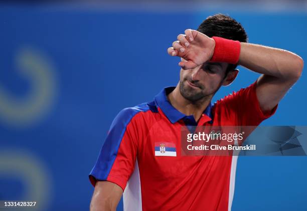 Novak Djokovic of Team Serbia wipes away sweat during his Men's Singles Semifinal match against Alexander Zverev of Team Germany on day seven of the...