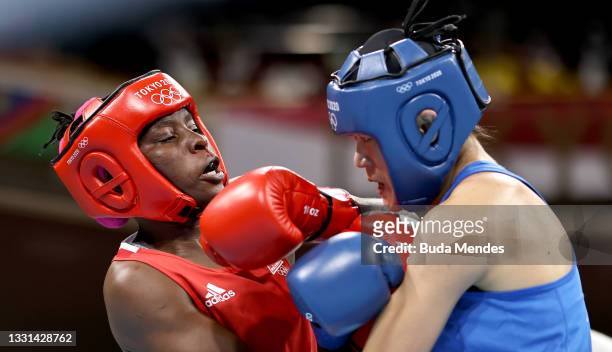 Alcinda Helena Panguana of Team Mozambique exchanges punches with Hong Gu of Team China during the Women's Welter quarter final on day seven of the...