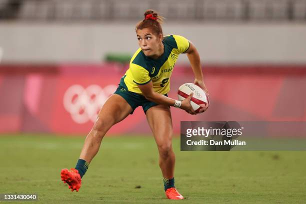 Faith Nathan of Team Australia passes in the Women’s Quarter Final match between Team Fiji and Team Australia during the Rugby Sevens on day seven of...