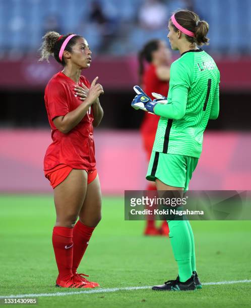 Desiree Scott of Team Canada speaks with teammate Stephanie Labbe during the Women's Quarter Final match between Canada and Brazil on day seven of...