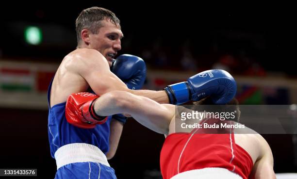 Eskerkhan Madiev of Team Georgia exchanges punches with Andrei Zamkovoi of Team Russian Olympic Committee during the Men's Welter quarter final on...