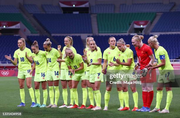Players of Team Sweden show encouragement after singing the national anthem prior to the Women's Quarter Final match between Sweden and Japan on day...