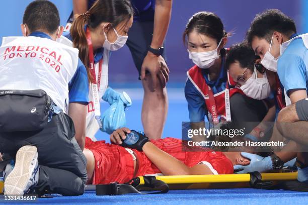 Shota Yamada of Team Japan is taken out of the pitch on a stretcher during the Men's Preliminary Pool A match between Japan and India on day seven of...