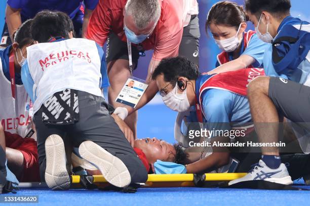 Shota Yamada of Team Japan is taken out of the pitch on a stretcher during the Men's Preliminary Pool A match between Japan and India on day seven of...