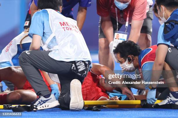 Shota Yamada of Team Japan is taken out of the pitch on a stretcher during the Men's Preliminary Pool A match between Japan and India on day seven of...