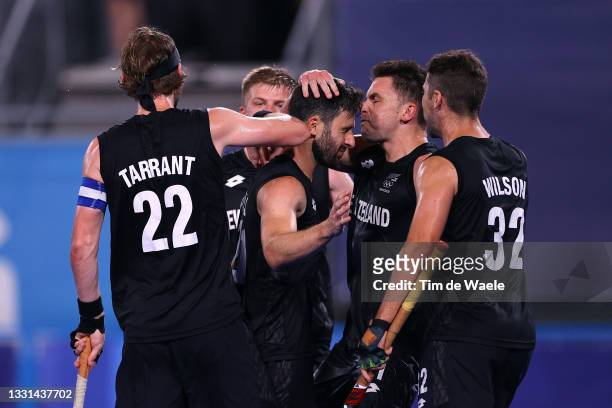 Kane Russell of Team New Zealand celebrates with teammates after scoring their team's first goal during the Men's Preliminary Pool A match between...