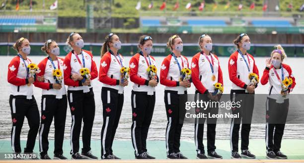 Coxswain Kristen Kit gestures for the crew to sing louder as Canada's national anthem is played during the medal ceremony for during the medal...