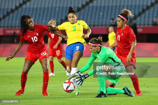 Stephanie Labbe of Team Canada collects the ball whilst under pressure from Debinha of Team Brazil during the Women's Quarter Final match between...