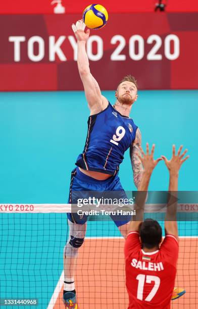 Ivan Zaytsev of Team Italy competes against Meisam Salehi of Team Iran during the Men's Preliminary Round - Pool A volleyball on day seven of the...
