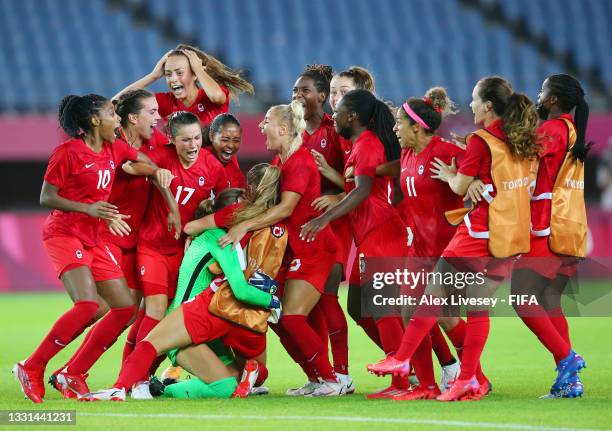 Stephanie Labbe of Team Canada celebrates victory with teammates after saving the Team Brazil fifth penalty taken by Rafaelle in a penalty shoot out...