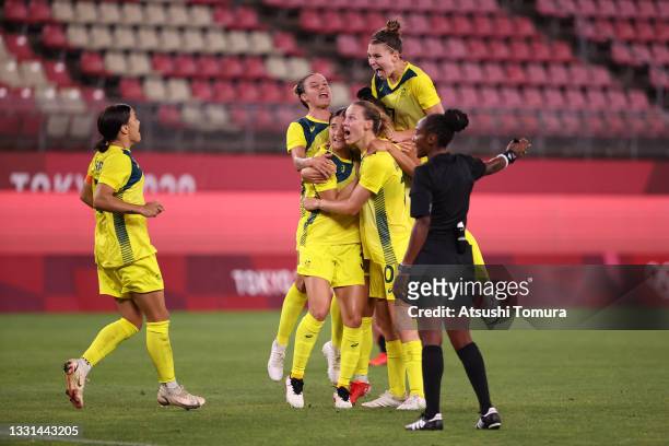 Mary Fowler of Team Australia celebrates with team mates after scoring their side's third goal during the Women's Quarter Final match between Great...
