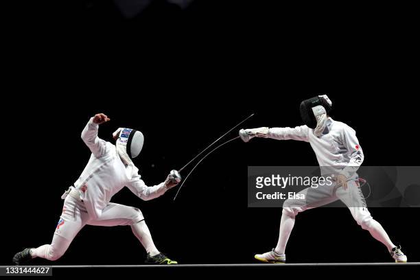Sergey Bida of Team ROC competes against Masaru Yamada of Team Japan during the Men's Épée Fencing Team Gold Medal Match on day seven of the Tokyo...