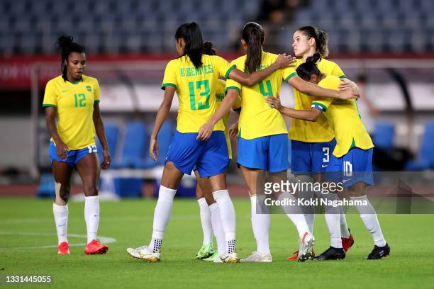 Erika of Team Brazil and teammates console following defeat in the penalty shoot out during the Women's Quarter Final match between Canada and Brazil...