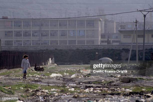 Woman walks during the passage of the Operation Albania - "Pellicano" convoy on March, 1992 in Elbasan, Albania. The economic and social problems in...