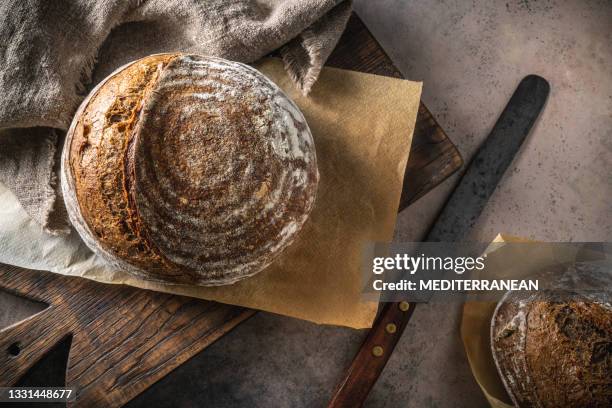 sourdough bread brown loaf homemade german style on cutting board - soda bread stock pictures, royalty-free photos & images
