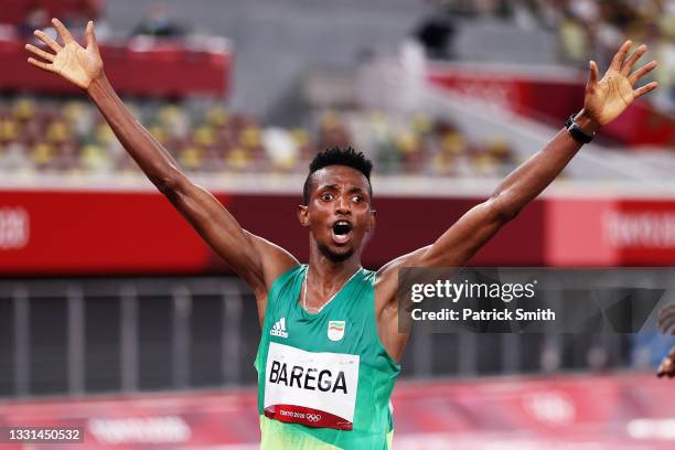 Selemon Barega of Team Ethiopia celebrates as he crosses the finish line to win gold in the Men's 10,000 metres Final on day seven of the Tokyo 2020...