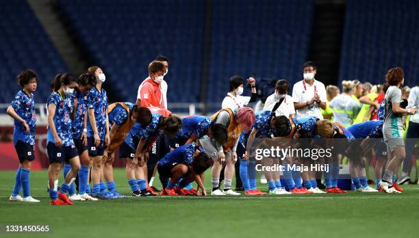 Team Japan look dejected following defeat in the Women's Quarter Final match between Sweden and Japan on day seven of the Tokyo 2020 Olympic Games at...