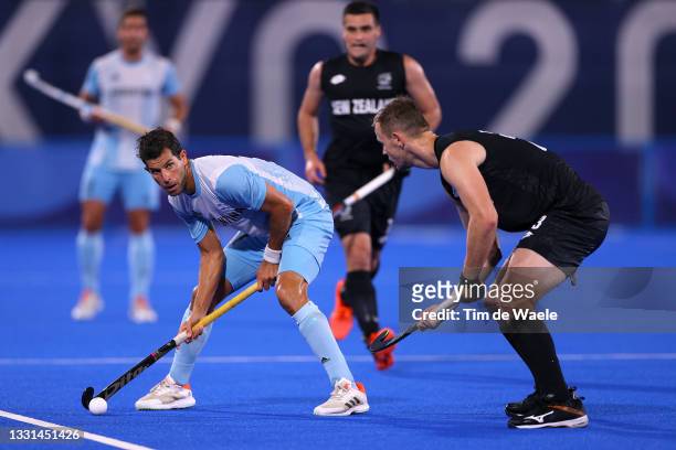 Juan Martin Lopez of Team Argentina holds the ball whilst under pressure from Dylan Thomas of Team New Zealand during the Men's Preliminary Pool A...