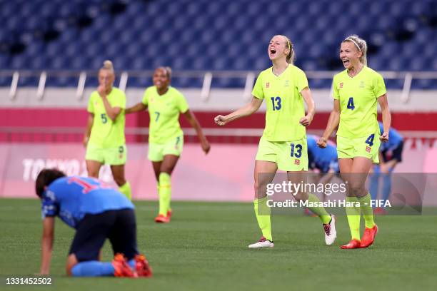 Amanda Ilestedt and Hanna Glas of Team Sweden celebrate after victory in the Women's Quarter Final match between Sweden and Japan on day seven of the...