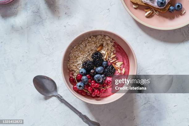 breakfast, smoothie bowl with fresh berries, rolled oats, almonds - porridge stock pictures, royalty-free photos & images