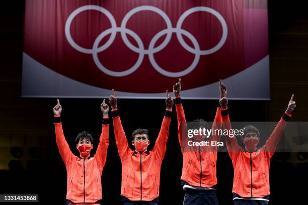 Team Japan pose with their gold medals on the podium after winning the Men's Épée Fencing Team Gold Medal Match against Team ROC on day seven of the...