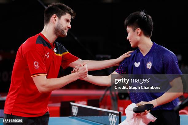 Dimitrij Ovtcharov of Team Germany shakes hands with Lin Yun Ju of Team Chinese Taipei after winning their Men's Singles Bronze Medal match on day...