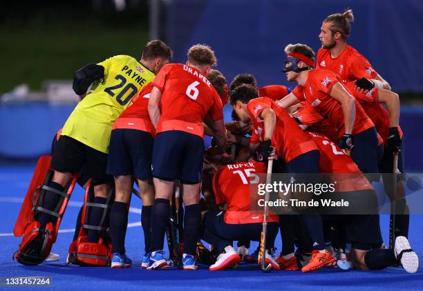 Team Great Britain huddle during the Men's Preliminary Pool B match between Belgium and Great Britain on day seven of the Tokyo 2020 Olympic Games at...