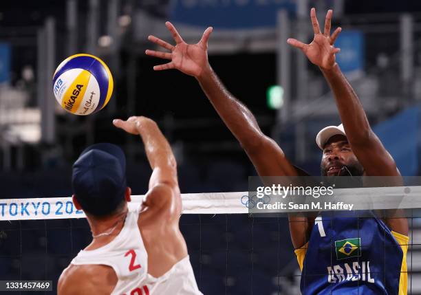 Grzegorz Fijalek of Team Poland competes against Evandro Goncalves Oliveira Junior of Team Brazil during the Men's Preliminary - Pool E beach...