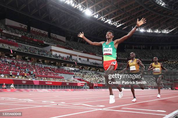 Gold medalist Selemon Barega of Team Ethiopia celebrates as he crosses the finish line ahead of silver medalist Joshua Cheptegei of Team Uganda and...