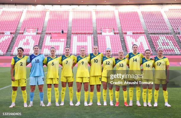 Players of Team Australia stand for the national anthem prior to the Women's Quarter Final match between Great Britain and Australia on day seven of...