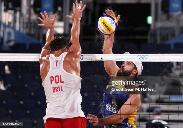 Bruno Oscar Schmidt competes against Michal Bryl of Team Poland during the Men's Preliminary - Pool E beach volleyball on day seven of the Tokyo 2020...