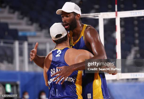 Evandro Goncalves Oliveira Junior and Bruno Oscar Schmidt of Team Brazil react after defeating Team Poland during the Men's Preliminary - Pool E...