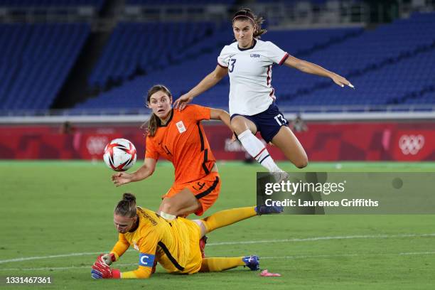 Alex Morgan of Team United States takes the ball over Sari van Veenendaal of Team Netherlands before scoring a goal which is later ruled out for...