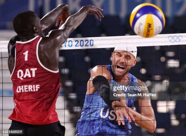 Cherif Younousse of Team Qatar competes against Jacob Gibb of Team United States during the Men's Preliminary - Pool C beach volleyball on day seven...