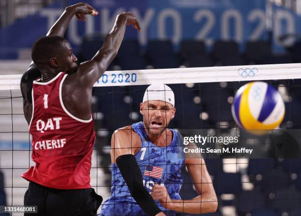Cherif Younousse of Team Qatar competes against Jacob Gibb of Team United States during the Men's Preliminary - Pool C beach volleyball on day seven...